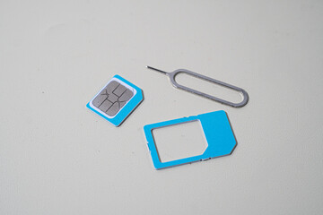 Close up macro of SIM card and SIM tray ejector tool