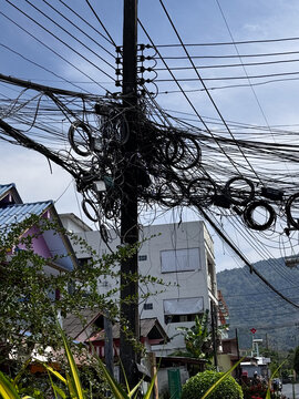 Chaotic overhead Asian wires on electric utility pole