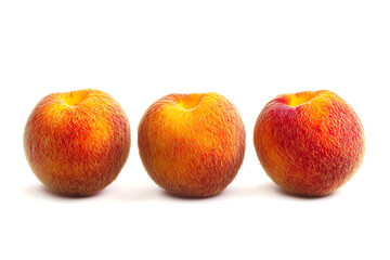 Three fresh peaches perfectly aligned present a vibrant, natural, and inviting scene perfect for healthy eating or summer fruit concepts.