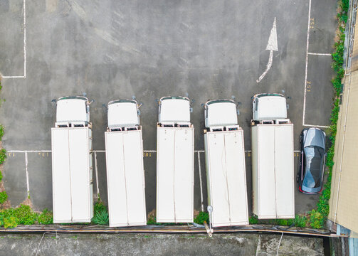 Aerial view white box trucks parking lot