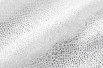 Close-up of white fabric with a fine weave.  Soft folds and creases are visible