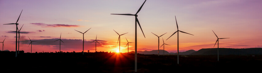 Aerial view of powerful Wind turbine farm for energy production on beautiful cloudy sky at...