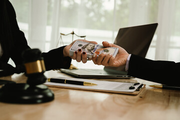 Two professionals are signing a legal agreement at a desk, with a judge’s gavel nearby. The scene reflects law, business contracts, and formal documentation.x