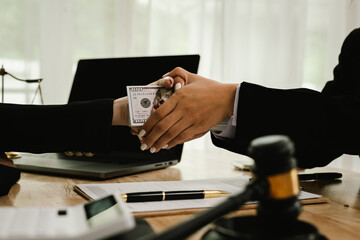 Two professionals are signing a legal agreement at a desk, with a judge’s gavel nearby. The scene reflects law, business contracts, and formal documentation.x
