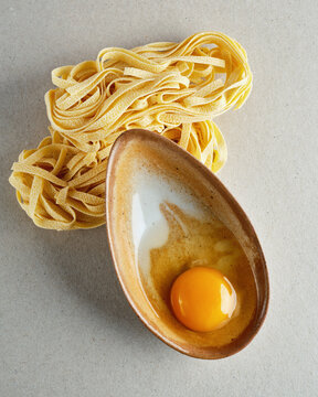 ceramic saucer with egg and pasta