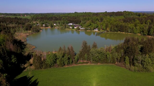 Aerial view of Esssee, a shrinking glacial lake near the Max Planck Institute for Biological Intelligence, in Seewiesen, Gemeinde Poecking, Landkreis Starnberg, Upper Bavaria, Germany in spring