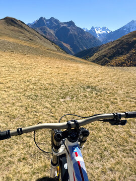 Downhill bike on trail in alpine mountain valley