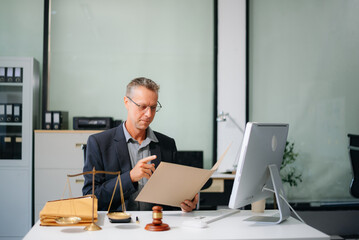 Male lawyer consulting on legal cases in a modern office. Ideal for law firms, corporate attorneys