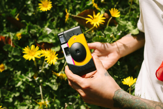 Capturing memories with a camera in a vibrant flower field