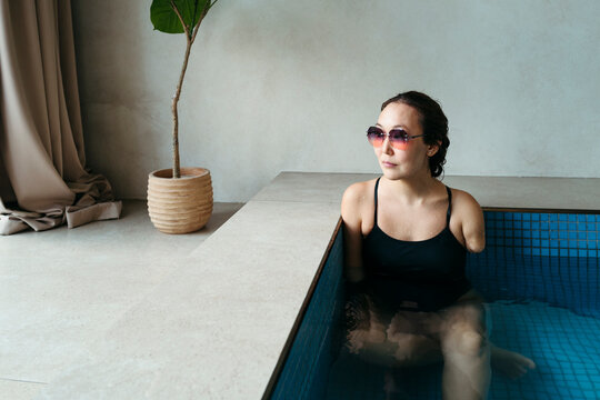 Relaxation and Reflection in a Tranquil Indoor Pool Setting