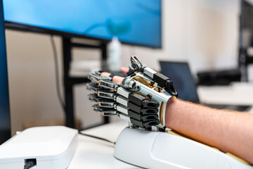 Engineer testing robotic prosthetic hand in laboratory
