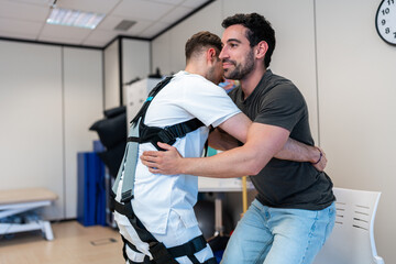 Physiotherapist assisting patient wearing rehabilitation suit