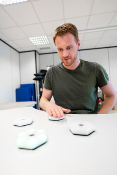 Engineer testing innovative interactive luminous device in laboratory