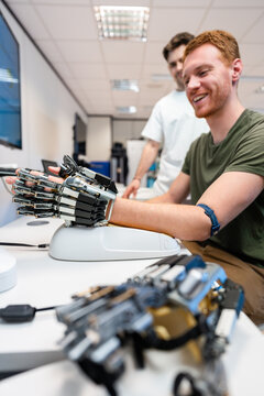 Engineers developing robotic hand prosthesis in laboratory