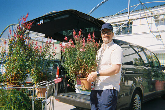 Man Loading Flowers in Car
