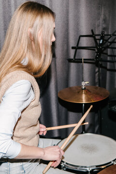  A young woman playing the drums.