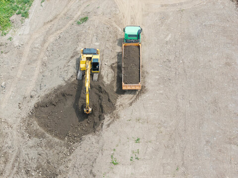 Aerial View Excavator Loading Truck at Construction Site.