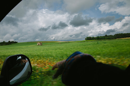 Scenic countryside drive highlighting lush fields and cloudy skies