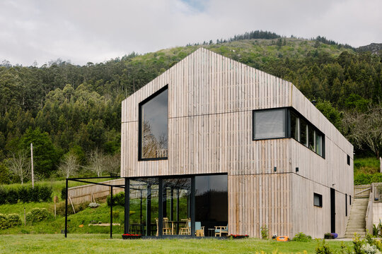 The facade of a sustainable wooden house with large windows