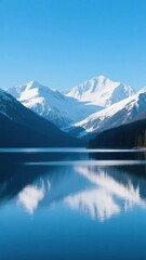 Obraz premium Snow-Capped Mountains Reflected in Calm Lake Waters