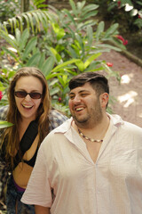 Fototapeta premium Happy Couple Laughing Together in Tropical Garden
