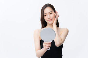 白バックでスキンケアをする若い女性