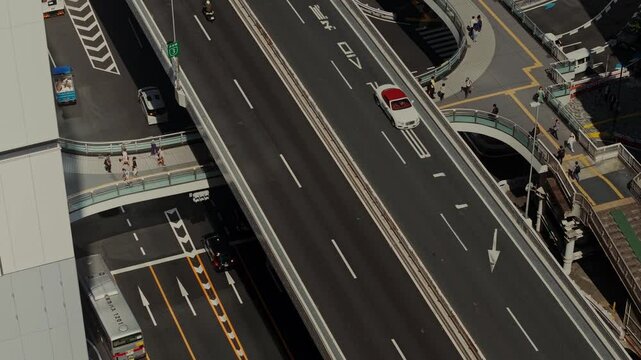 Bird's-eye view of a busy road junction with pedestrian crossings. Tokyo, Japan from a drone