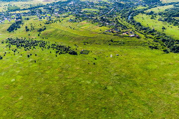 Village located on an elevation relative to the surrounding floodplain, a view from a great height...