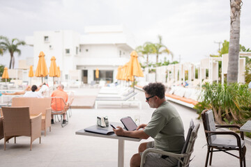 Businessman Working at Poolside Bar Terrace