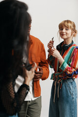 Young adult woman socializing with colleagues and coworkers during a casual business meeting in a modern workplace environment, representing Gen Z work and friendship.