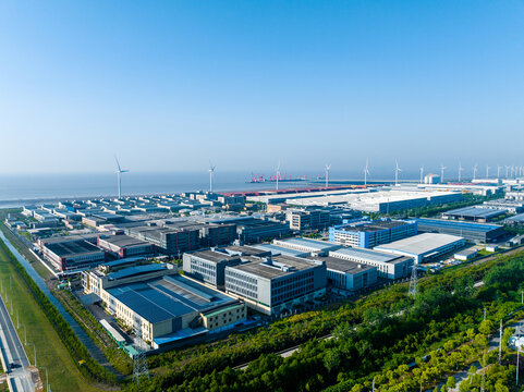 Aerial View of Coastal Industrial Park with Wind Power and Factory Bui
