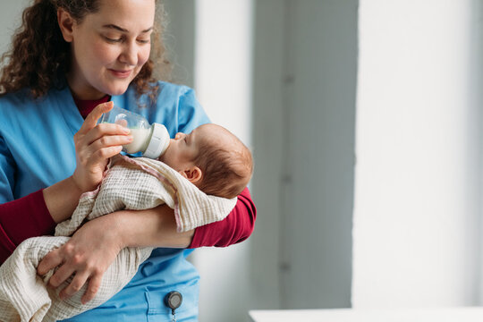 Nurse feeding baby