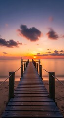 Obraz premium Wooden pier leading to a vibrant sunset over a calm ocean