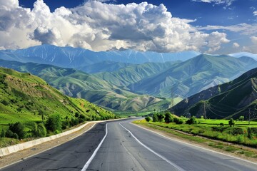 Naklejka premium Winding road through lush mountain valley under a vibrant sky