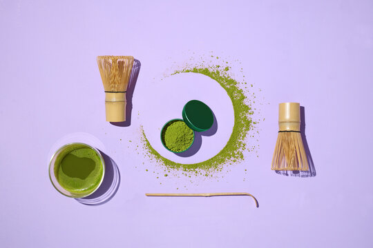 Matcha tea ceremony setup beautifully arranged on a purple background