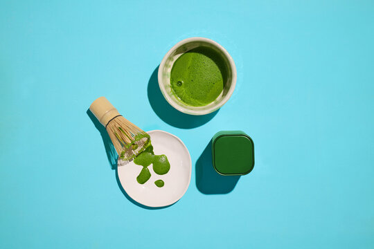 A refreshing matcha tea ceremony is depicted with traditional tools