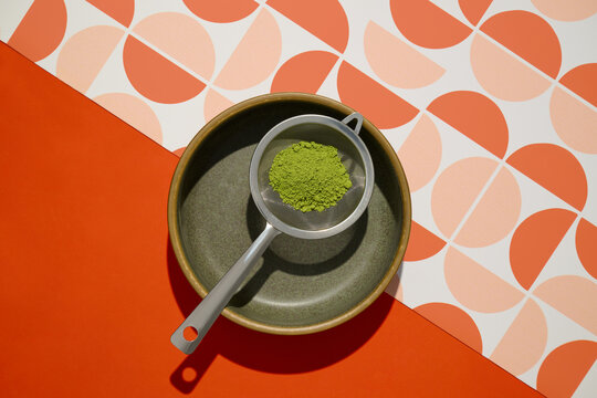 Vibrant overhead shot features matcha powder on pattern background