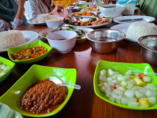 Colorful Array Of Traditional Dishes And Fresh Ingredients On A Wooden Table