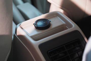 Power outlet in a vehicle console for charging devices