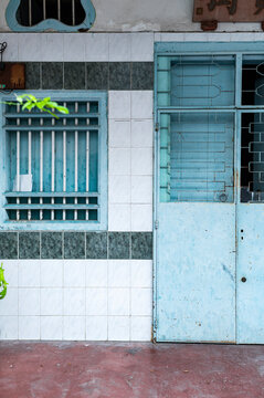 Light blue tiled facade with white colonial grid
