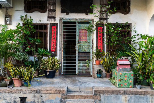 Rusty turquoise door with Chinese scrolls and house plants 