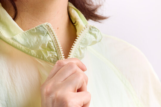 Woman zips up her jacket