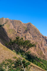 Beautiful mountain slopes captured on the scenic drive to Sembalun – Lombok, offering a glimpse of the grandeur leading to majestic Mount Rinjani.