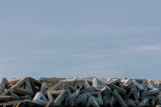 Geometric art of the coast: A dolos array under the setting sun.
