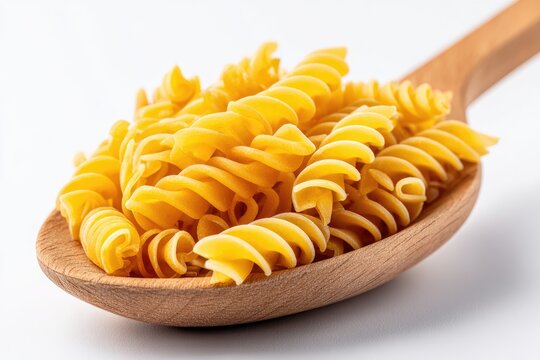 Spiral pasta in a wooden spoon.