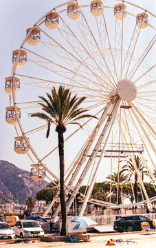 film image of a Ferris wheel on the beach in Menton, French Riviera