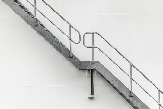 Metal stairway on a white wall