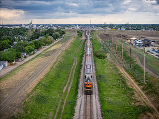 Train is traveling down a track in a rural area