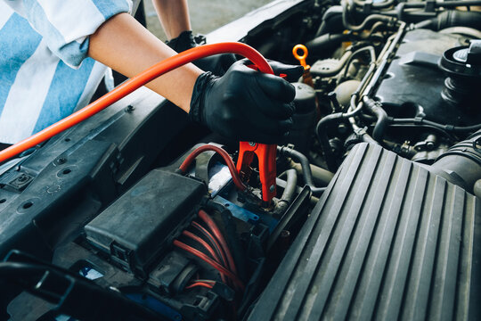 Mechanic Jump Starting Car
