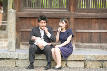 In June 2025, a young Japanese couple in their early twenties enjoys their baby's omiyamairi by...